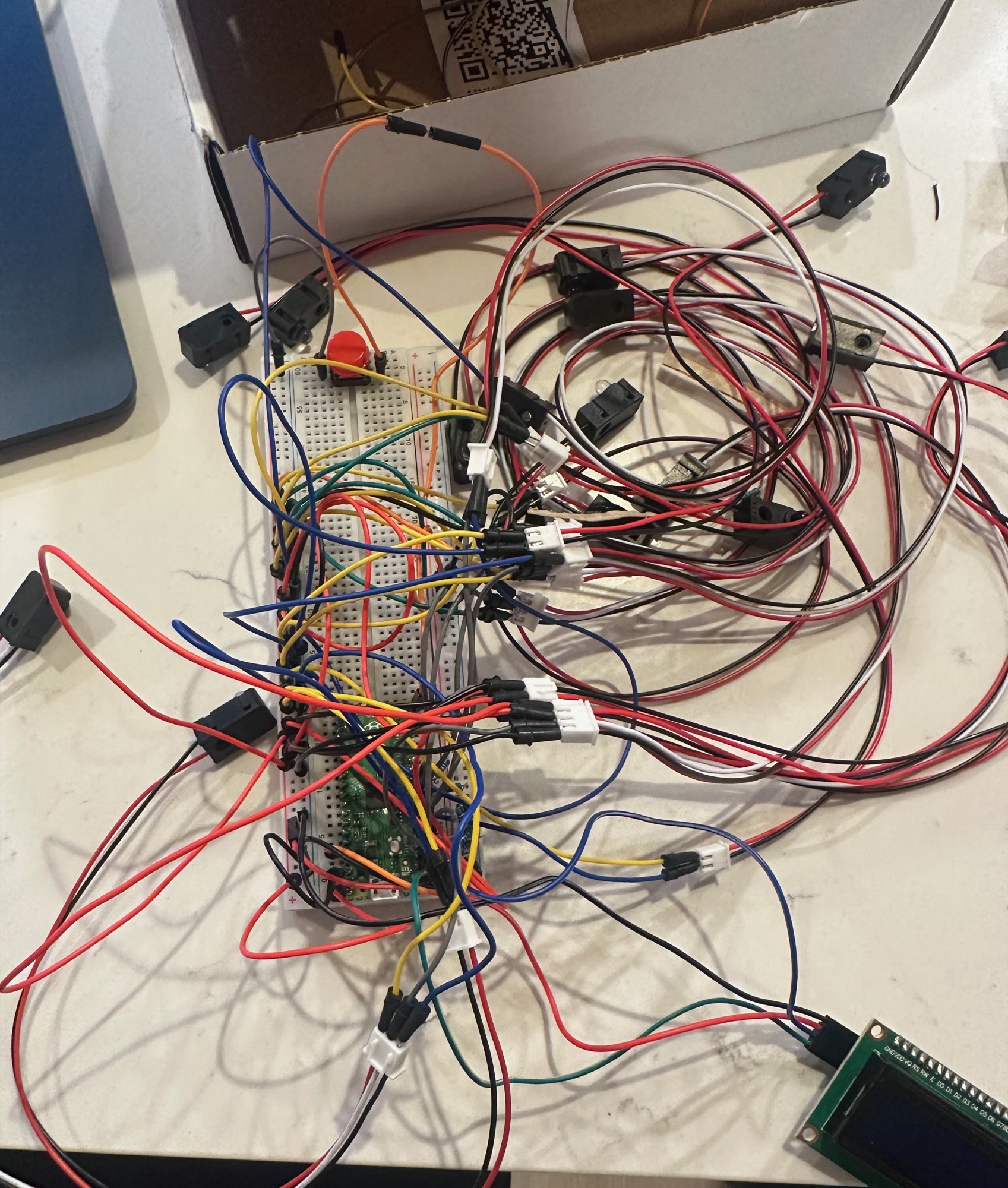 The Raspberry Pi Pico wired to the IR sensors, LCD, and pushbutton